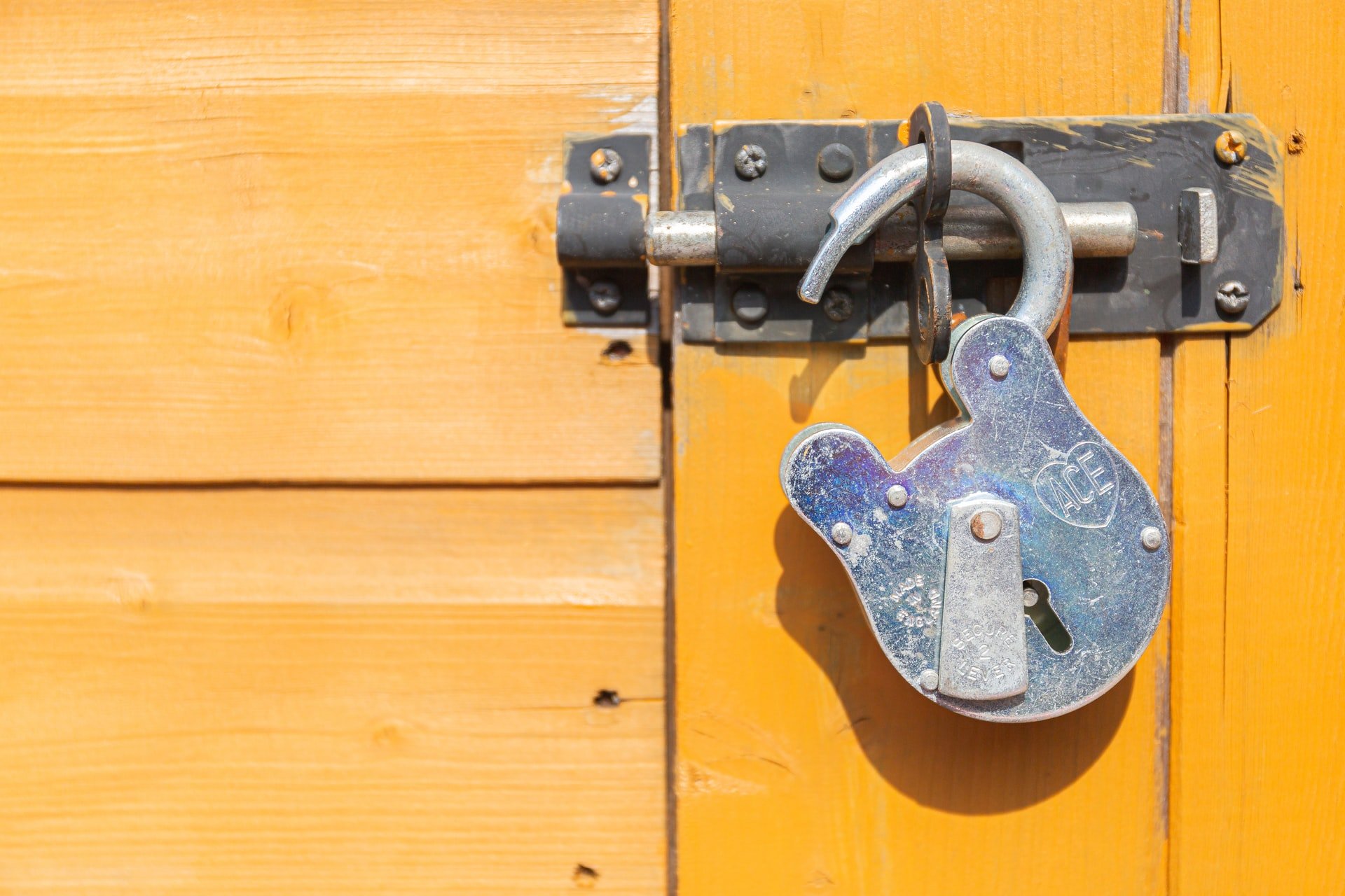 A padlock on a shed.