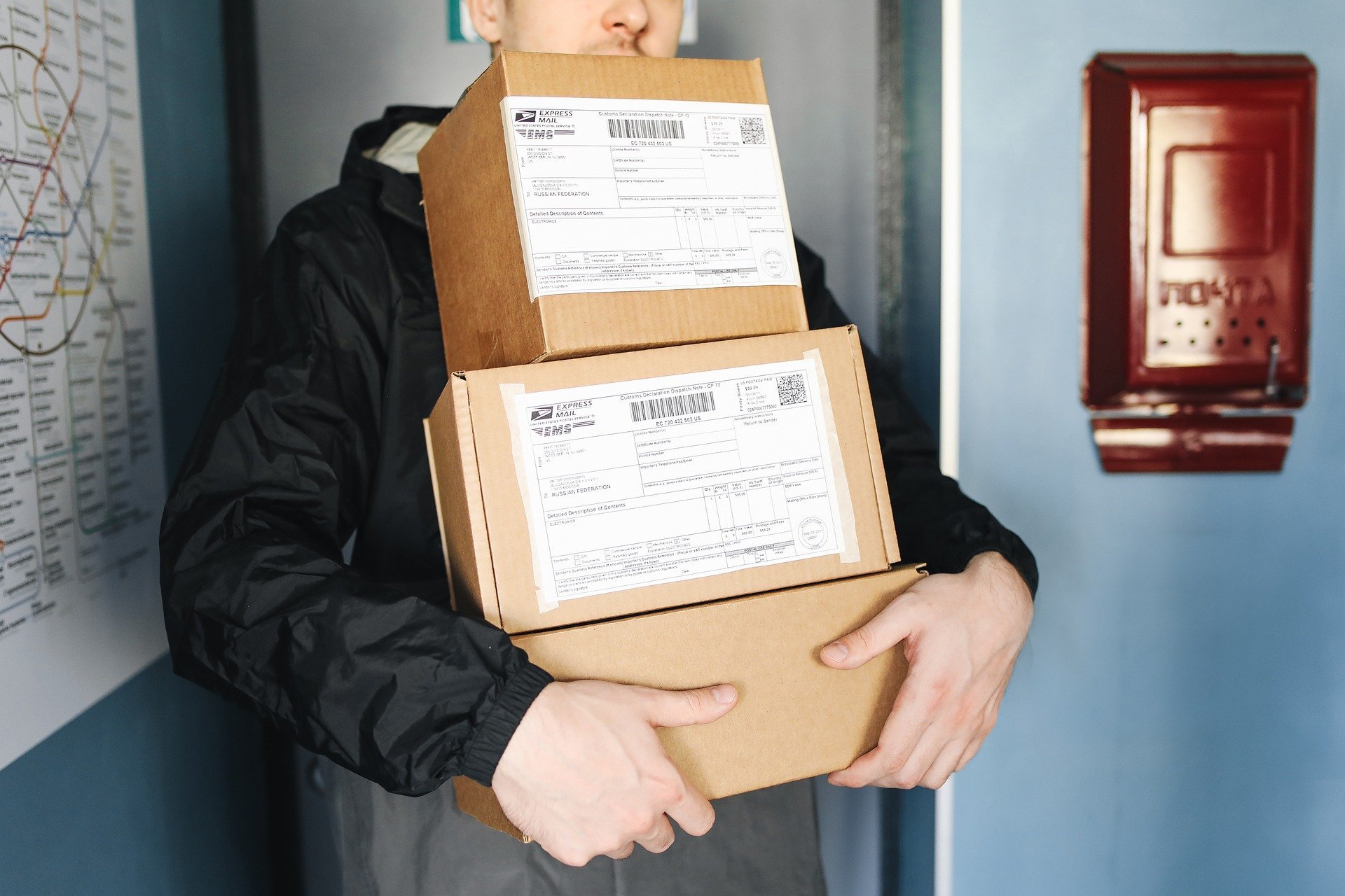 A man carrying three parcels.